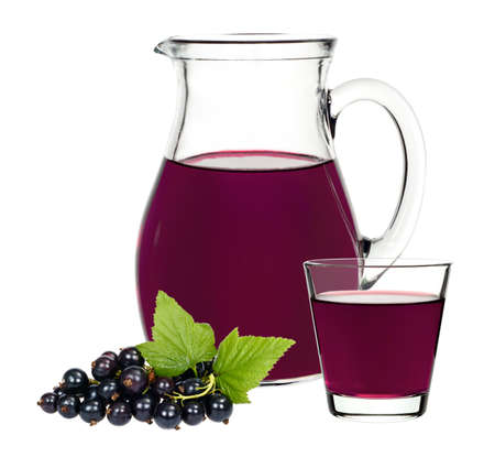 Currant drink in a glass and a decanter with berries currants on a white backgroundの写真素材