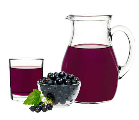 Currant drink in a glass and a decanter with berries currants on a white backgroundの写真素材