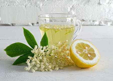 Fresh elderberry flower drink with sliced lemon on white table. Ð¡lose-up.の写真素材