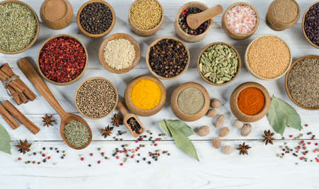 Spices and condiments for cooking on white wooden background. Top view. Flat lay.の写真素材