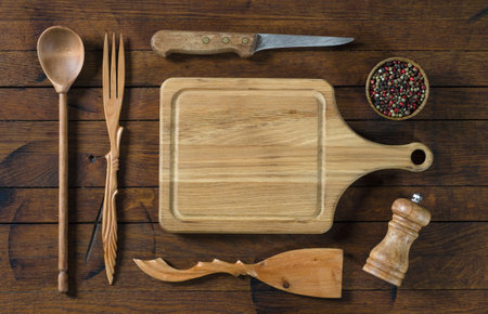 Wooden kitchen utensils and kitchen board on old wood tablein rustic style with copy space for your text. Top view. Flat lay.の写真素材