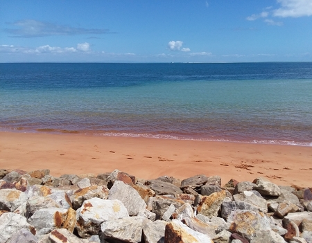 North Stradbroke Island off the east coast of Australia. Iron deposits create the orange hue on the sand and the rocks.の写真素材