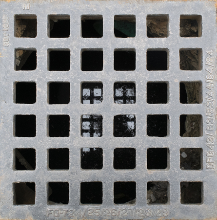 Storm drain in paved roadの写真素材