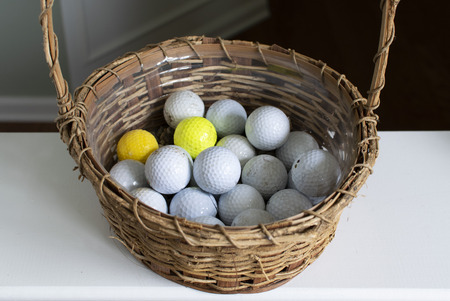 Golf balls inside wicker basketの写真素材