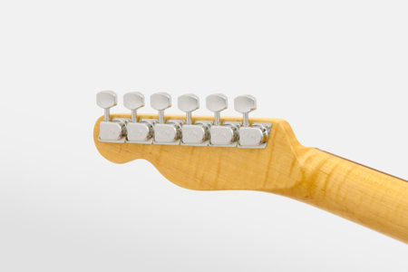 Detail of headstock rear part of headstock of guitar musical instrument on white backgroundの写真素材