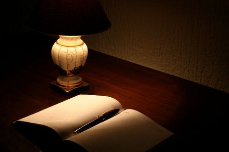 Planner and lamp on desktopの写真素材