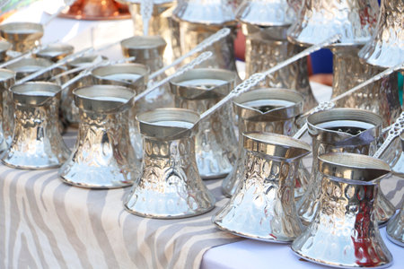 Traditional handmade copper coffee pots crafted with engraved detailsの写真素材