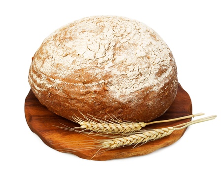 Traditional rye bread and wheat on a wooden board, isolated on white background 