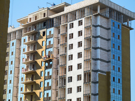 ODESSA - SEPTEMBER 12: facade thermal insulation works with stopping and fillers during the...