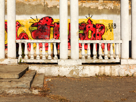 ODESSA - NOVEMBER 1: Old abandoned building with columns, graffiti on a wall. Grungy concrete surface with cracks, scratches and streaks of paint. November 1, 2015 in Odessa, Ukraineのeditorial素材