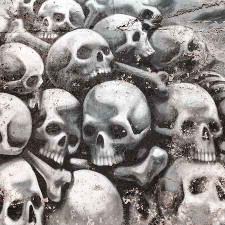VARNA - November 11: Detail of graffiti on the wall of a pile of skulls and bones. Grungy concrete surface with cracks, scratches and streaks of paint. November 11, 2015 in Varna, Bulgariaのeditorial素材