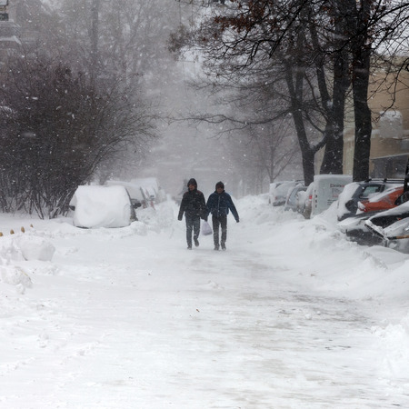 ODESSA - January 18, 2016: On snow-covered street. People go along the street during a snowfall. January 18, 2016 in Odessa, Ukraineのeditorial素材