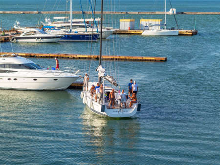 Odessa, Ukraine July 6, 2016: Yacht Club with parked vehicles of various models. Pleasure boat with tourists depart from the pier in Odessa, Ukraine, July 6, 2016のeditorial素材