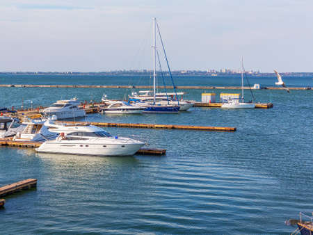 Odessa, Ukraine July 6, 2016: Yacht Club with parked vehicles of various models. Pleasure boat with tourists depart from the pier in Odessa, Ukraine, July 6, 2016のeditorial素材