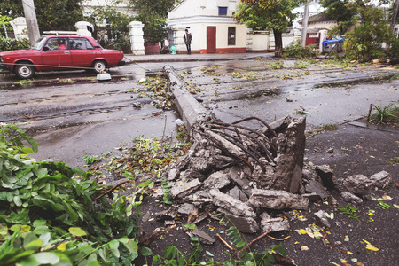 Odessa, Ukraine - October 12, 2016: Hurricane CHRISTIE. Heavy rain and gale - force gusts of wind caused accident - old tree during storm fell on car and destroyed house. Strong storm with rainのeditorial素材