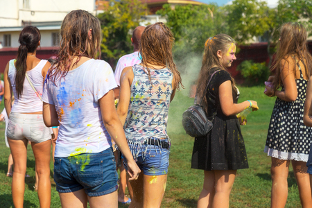 ODESSA, UKRAINE - August 5, 2017: Young people, boys and girls have fun during Holi holiday, throwing colorful powder into each other. Festival of Colored Paint, of colors love in Odessa. Color festのeditorial素材