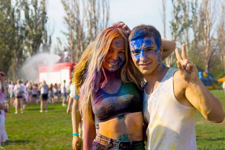 ODESSA, UKRAINE - August 5, 2017: Young people, boys and girls have fun during Holi holiday, throwing colorful powder into each other. Festival of Colored Paint, of colors, love. Color festのeditorial素材