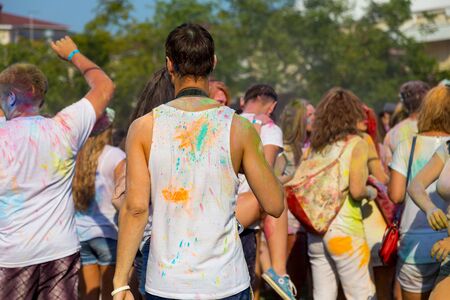 ODESSA, UKRAINE - August 5, 2017: Young people, boys and girls have fun doing selfie during festival of Holi by throwing coloured powder at each other. Festival of Colored Paint, colors love. Color festのeditorial素材