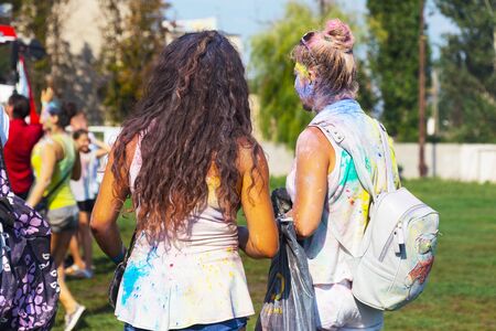 ODESSA, UKRAINE - August 5, 2017: Young people, boys and girls have fun during Holi holiday, throwing colorful powder into each other. Festival of Colored Paint, of colors, love. Color festのeditorial素材