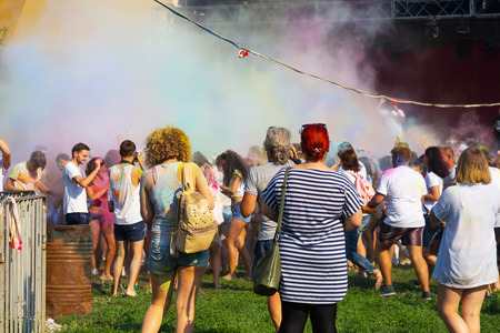 ODESSA, UKRAINE - August 5, 2017: Young people, boys and girls have fun doing selfie during festival of Holi by throwing coloured powder at each other. Festival of Colored Paint, colors love. Color festのeditorial素材