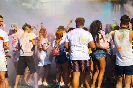 ODESSA, UKRAINE - August 5, 2017: Young people, boys and girls have fun doing selfie during festival of Holi by throwing coloured powder at each other. Festival of Colored Paint, colors love. Color festのeditorial素材