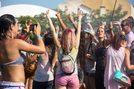 ODESSA, UKRAINE - August 5, 2017: Water festival. Party wet. Hands and happy people crowd partying under rain at holi fest, festival of colors in summer, amazing moment. Color festのeditorial素材