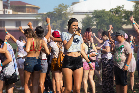 ODESSA, UKRAINE - August 5, 2017: Water festival. Party wet. Hands and happy people crowd partying under rain at holi fest, festival of colors in summer, amazing moment. Color festのeditorial素材