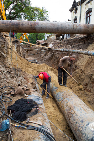 ODESSA, UKRAINE - OCTOBER 11, 2016: Repair of city water supply. Replacement of old rusty metal pipes on plastic pipes. New modern technologies of urban engineering networks. City Water Pipelineのeditorial素材