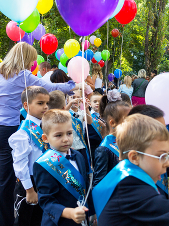 ODESSA, UKRAINE - September 01, 2017: Joyful children. First graders going to school with multi-colored balloons 01 September in Odessaのeditorial素材