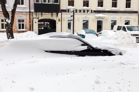 Odessa, Ukraine - January 01, 2015: Snow drifts in the city on a winter frosty day. Car blocked in the yard by snowdrifts after the heavy snow stormのeditorial素材