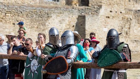 ODESSA, UKRAINE - JULY 20, 2019: Battle of the Knights with medieval weapons at the medieval performance. Knights fight on the field during the battle tournament of the festival of medieval cultureのeditorial素材