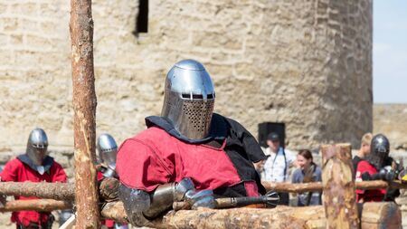 ODESSA, UKRAINE - JULY 20, 2019: Battle of the Knights with medieval weapons at the medieval performance. Knights fight on the field during the battle tournament of the festival of medieval cultureのeditorial素材