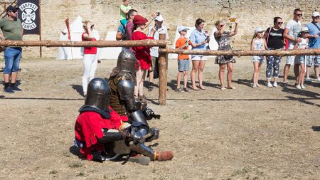 ODESSA, UKRAINE - JULY 20, 2019: Battle of the Knights with medieval weapons at the medieval performance. Knights fight on the field during the battle tournament of the festival of medieval cultureのeditorial素材