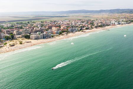Suny Beach, Bulgaria - August 09, 2019: Aerial image a drone resort in Bulgaria on Black Sea coast. Many hotels and beaches with tourists, sunbeds and umbrellas. Sea travel destination. Travel and vacation concept.のeditorial素材