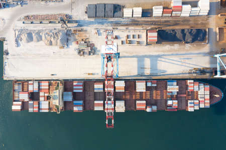 ODESSA, UKRAINE - AUGUST 10, 2021: Loading a container ship at seaport. Industrial commercial containers at sea loading container terminal. Merchant fleet, cargo transportation. Marine logisticsのeditorial素材