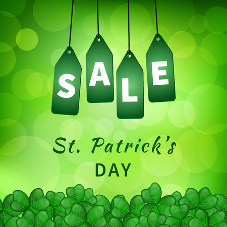 Sale poster of Saint Patrick's day with emerald shamrocks on green background bokeh and hanging green tags. Vector illustrationのイラスト素材