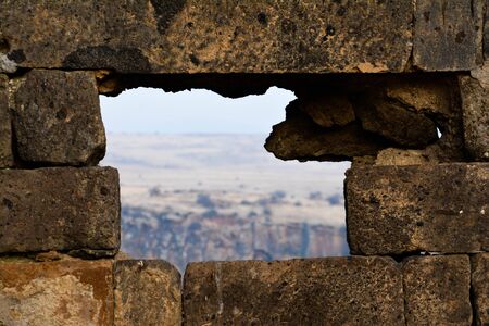 A stone window looks directly into the fields