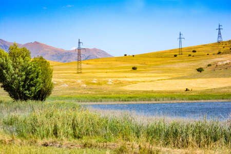 Golden autumn fields and lakeの写真素材