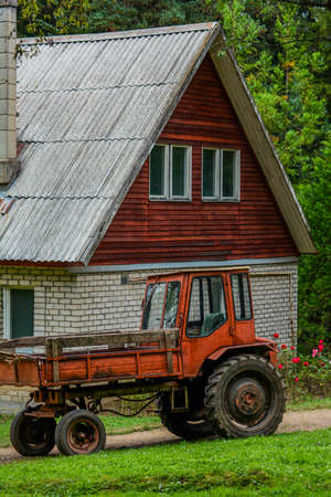 Red tractor in the forestの写真素材