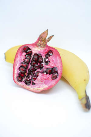 Pomegranate grain and banana. Composition of fruitsの写真素材