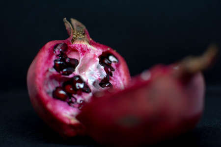How to choose a delicious pomegranate. Red pomegranate on the tableの写真素材