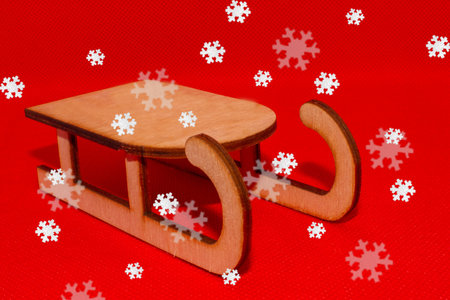 Sleigh on a red background and snowflakes