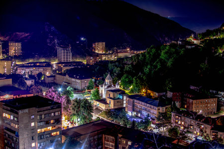 Church in the middle of houses in the night city. Beautiful colors of the night cityの写真素材