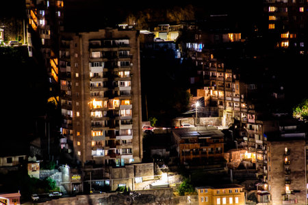 Glowing houses in the night city. Life in the night city. The city sleeps. Big city lifeの写真素材
