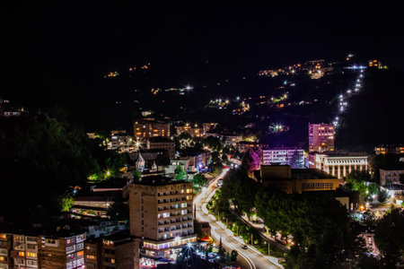 A beautiful night city with bridges and rivers. Driving cars at an intersection with a traffic light. Beautiful night cityscapeの写真素材