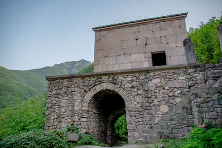 Small old temple in the middle of the mountains. Beautiful forest landscape with a temple