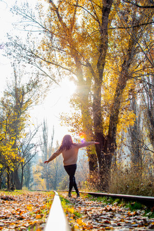 Girl in the woods. The girl walks on the railroad in the forest. Fairy forest and girlの写真素材