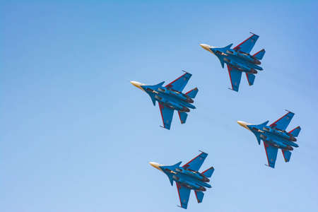 Four military planes in the sky are showing a show. Military fighters Su-30 SM. Bombers fly in the skyの写真素材