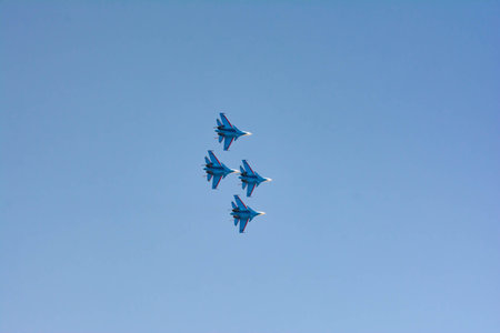 Aviation pilots demonstrate high aerobatics on fighters. Aircraft bombers in the blue sky. Military aircraft in the skyの写真素材