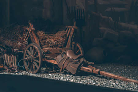 Old village wooden cart to transport grass and wheat. Horse saddle. Village atmosphereの写真素材